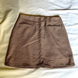 Gingham burnt orange, black, and white mini skirt with false front pockets